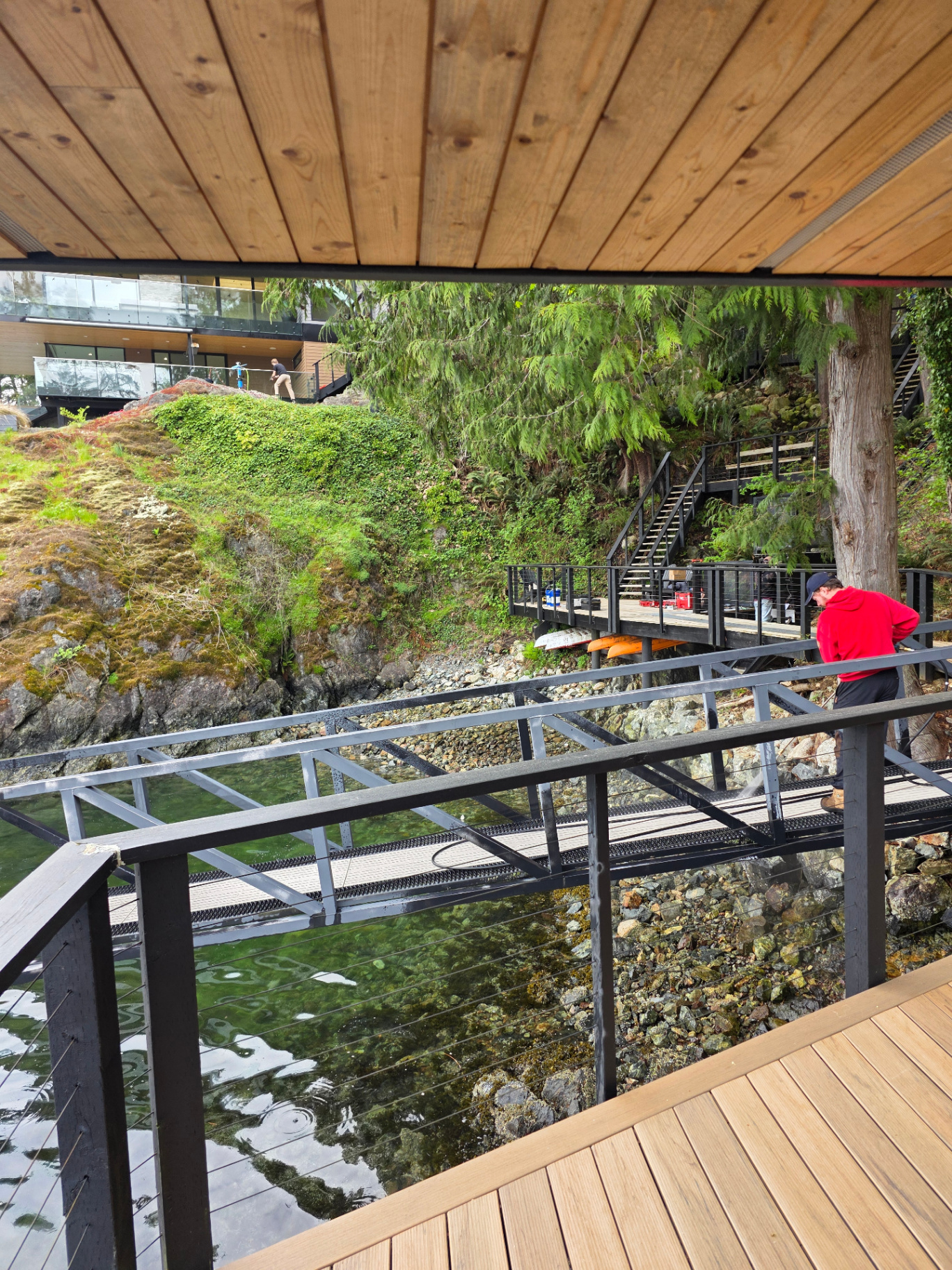 Complete Window Cleaning crew on-site at a waterfront property assessing the home before starting work
